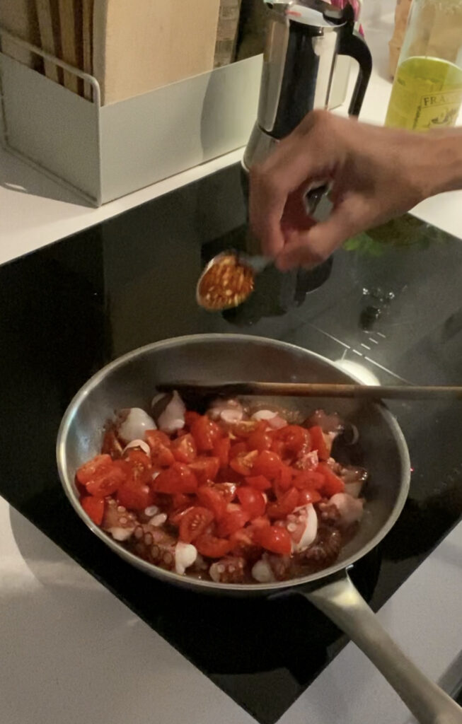 Pfanne mit Tomaten und Oktopus und Chili