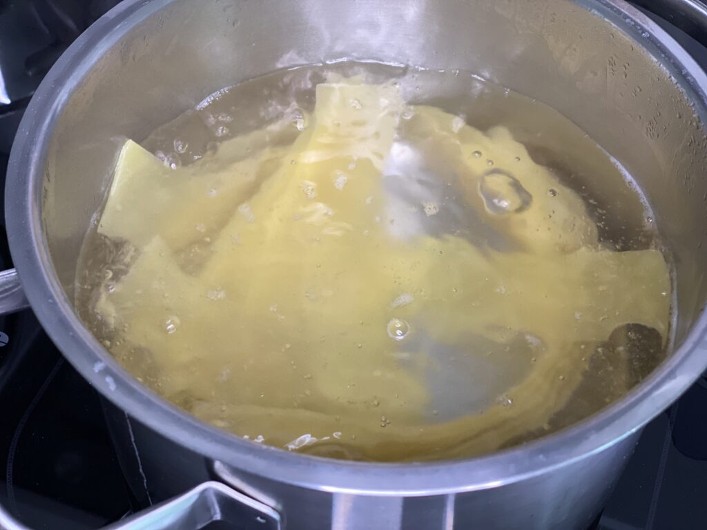 Lasagneplatten kochen im Topf mit Wasser